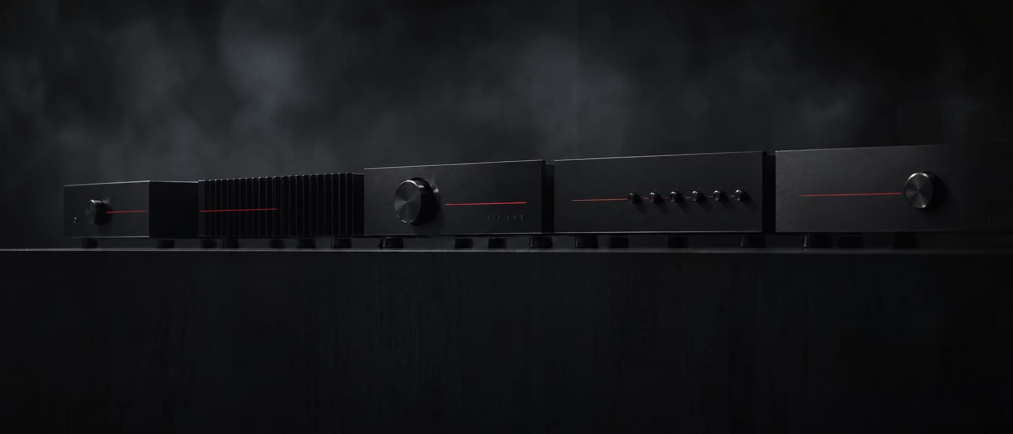 A wide bench of matte black instruments with thin red indicator lines